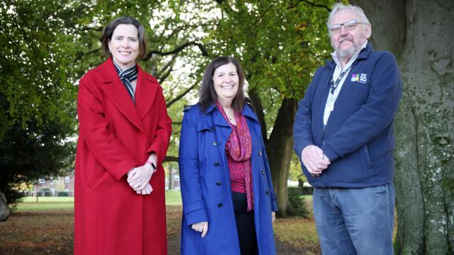 Claire Griffith, Sasha Deepwell and Ralph Rudden standing on the path next to multiple trees