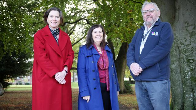 Claire Griffith,  Sasha Deepwell and Ralph Rudden standing on the path next to multiple trees