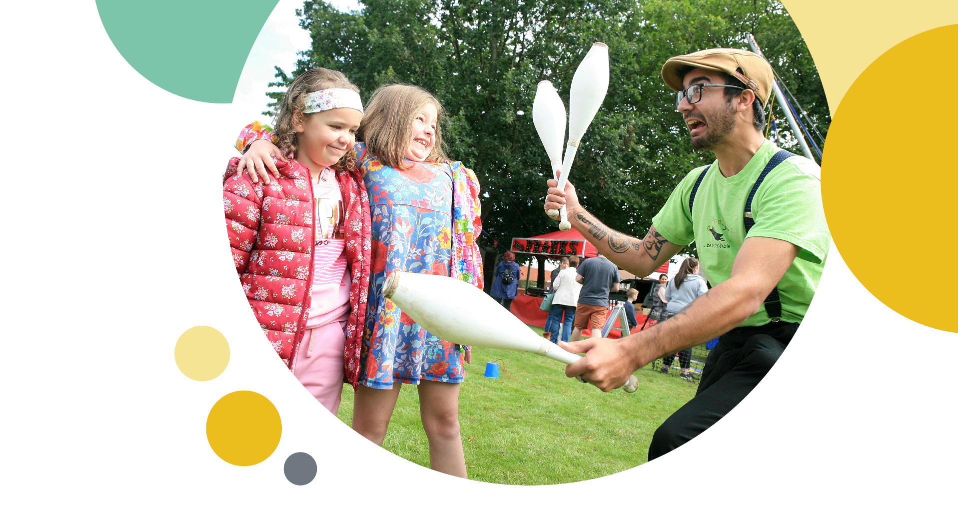 Man juggling next to two kids