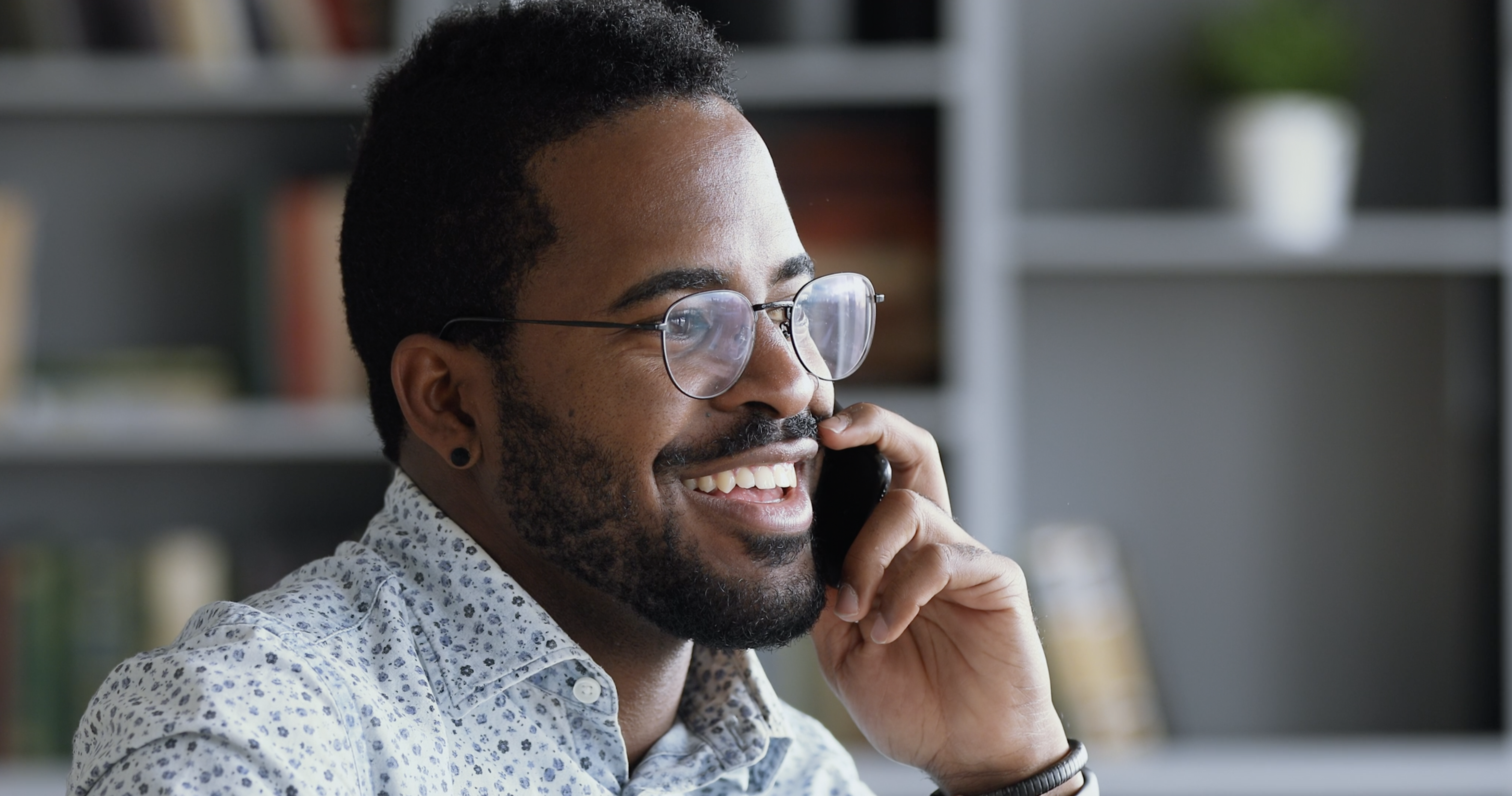 Man on the phone looking joyous 