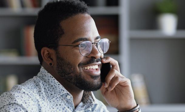 Man on the phone looking joyous 