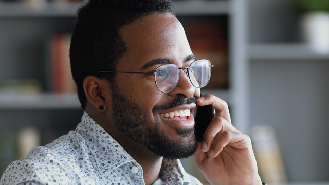 A man on the phone looking happy