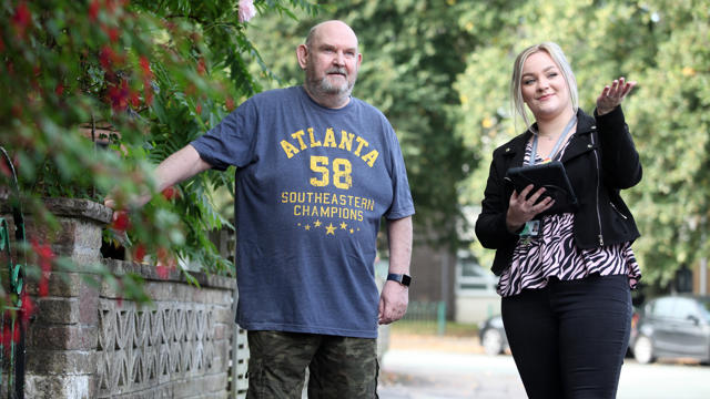 Irwell Valley Employee showing a resident around the area walking on the path 