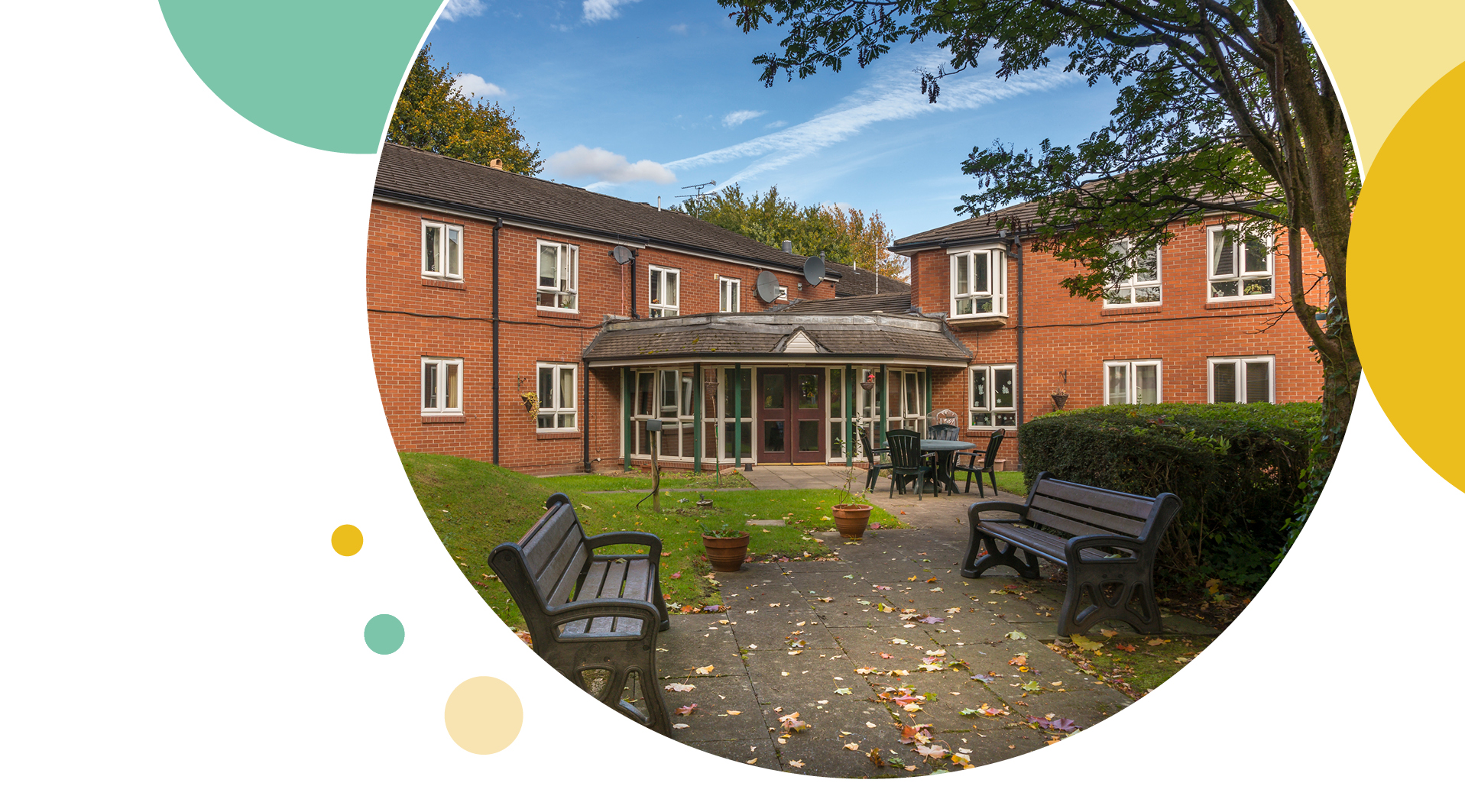 Front of our property with two benches in a flowery garden