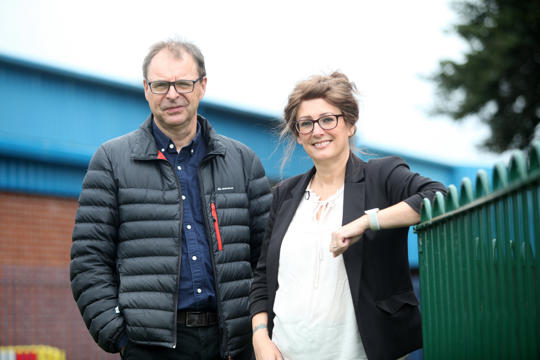 Irwell Valley Employees leaning on a green fence