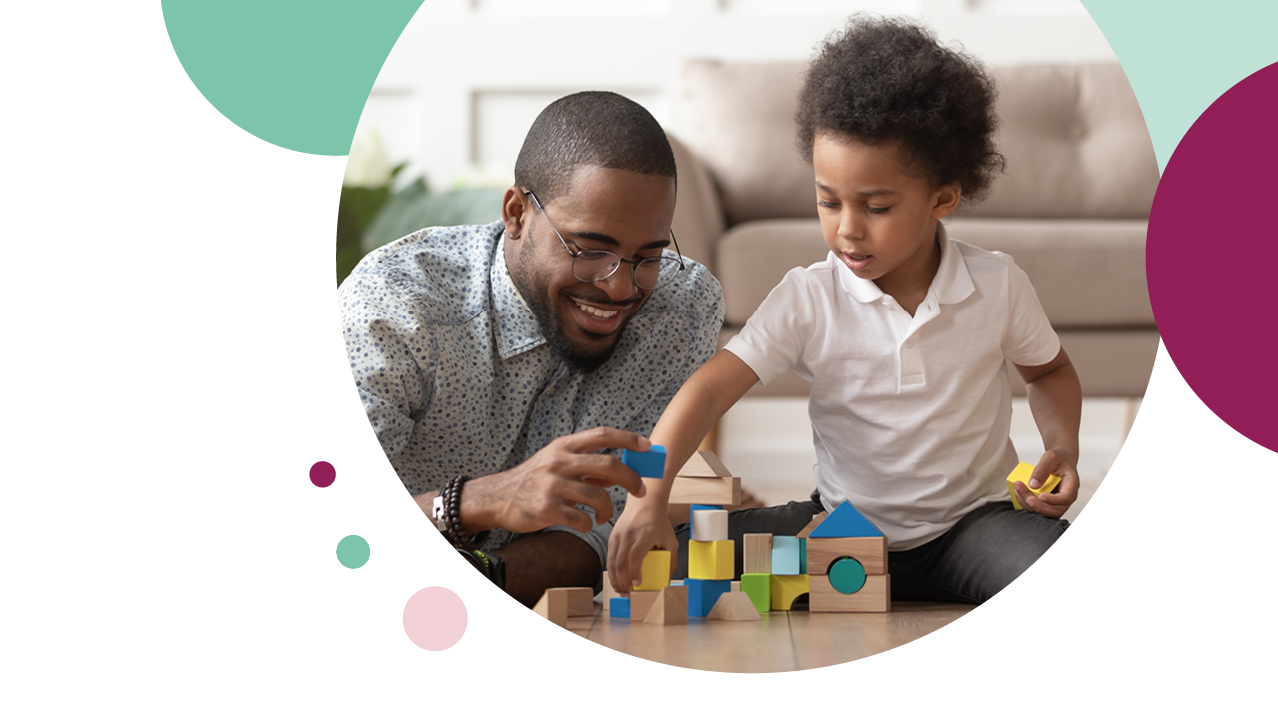 Man and child playing with wooden blocks 