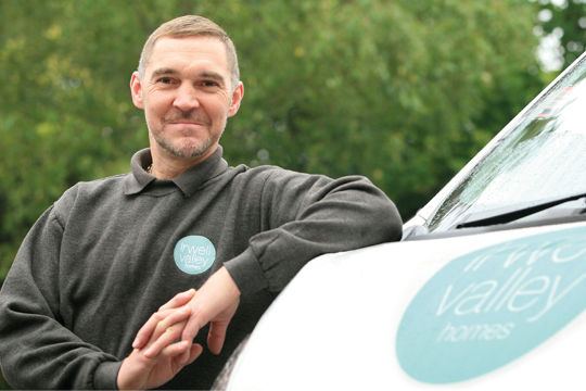 An Irwell Valley Employee posing on his van