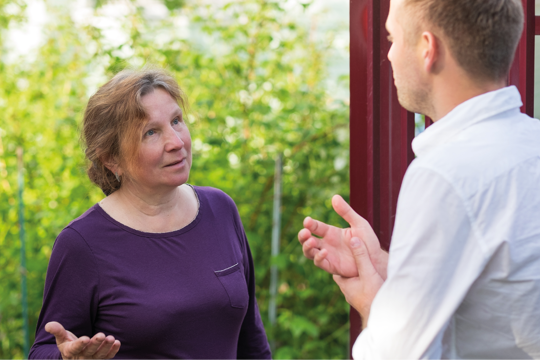 A man talking with a woman outside 