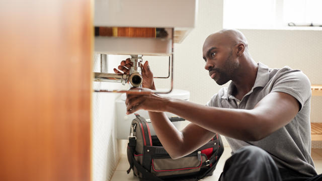 Irwell Valley Employee fixing the sink 