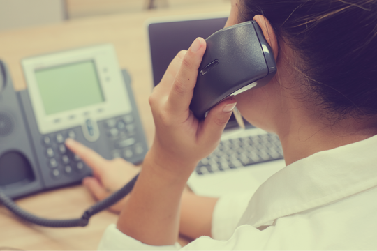 Woman on the phone pressing the button