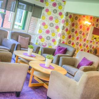 Green chairs with purple pillows in the communal room