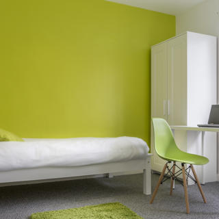 Room with green wallpaper and white furniture