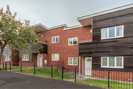 Three houses made of wood and brick