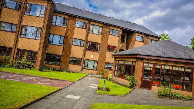Our property with lots of glass windows and a large garden