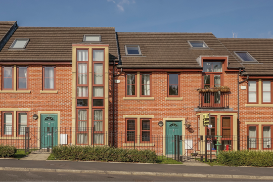 Two house next to each other with green doors