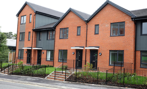 Chorley place from the front with four black front doors