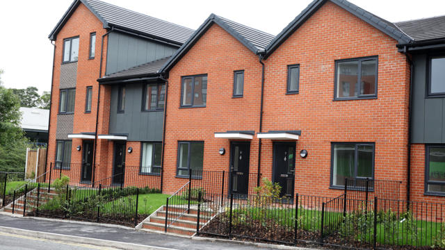 Chorley place from the front with four black front doors