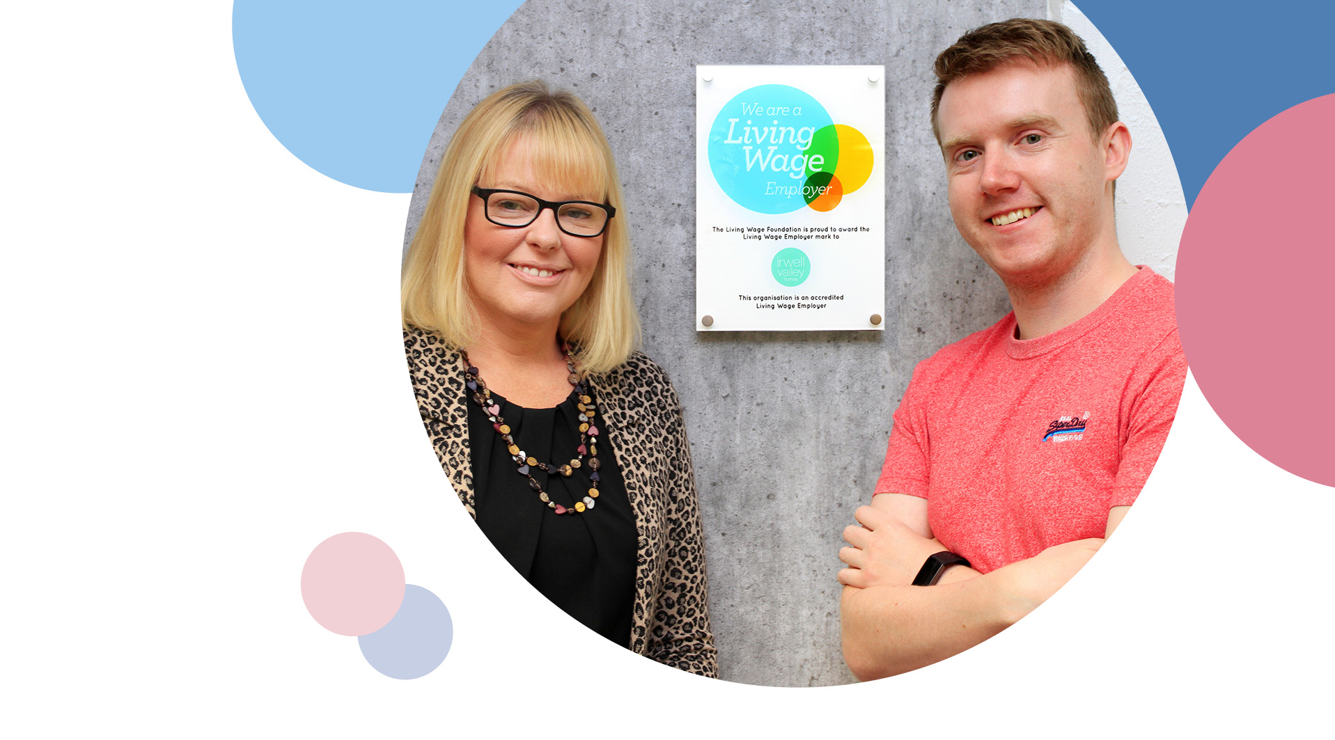 Two Irwell Valley Employees on either side of the living wage poster