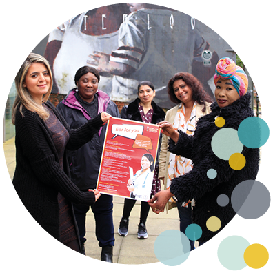 Four Woman holding a red eat for your health poster 