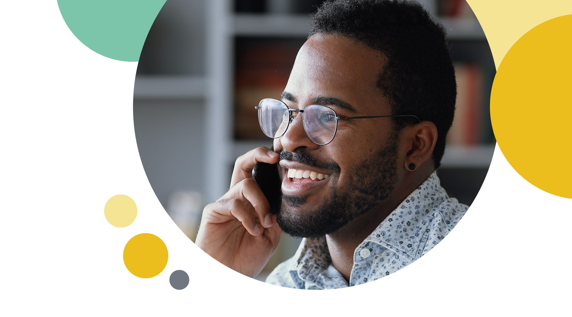 A man taking on the phone with a smile 