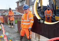 Three construction workers in orange Hi vis and blue hard hats 