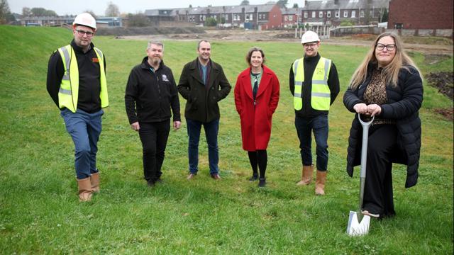 Irwell Valley staff on the field with a shovel 