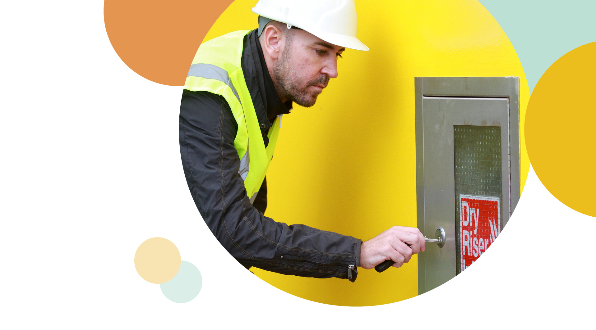 Irwell valley Employee in a hi vis and hard hat checking the Dry Riser Outlet