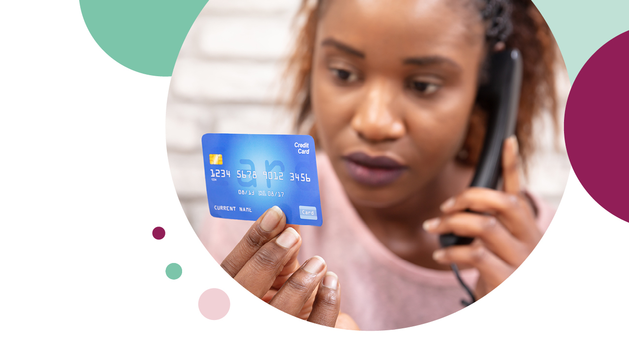Woman on the phone analysing her credit card