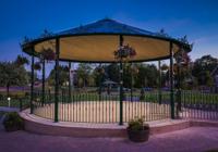 Carousel l in dark lighting with flowers and lights wrapped around it