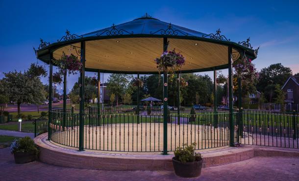 Carousel l in dark lighting with flowers and lights wrapped around it