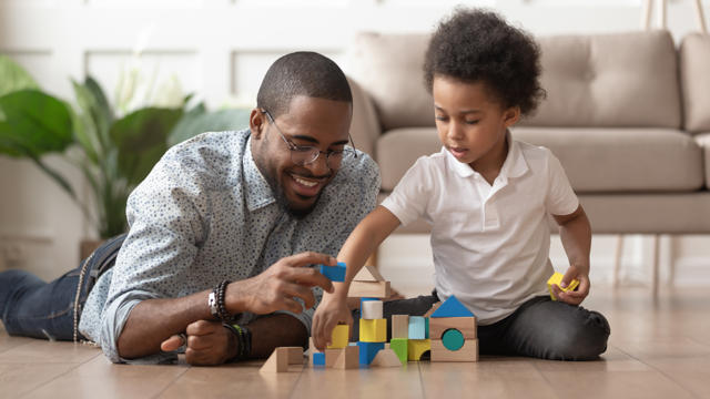 Man building block with his child