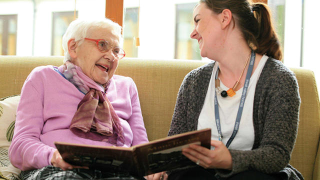 Irwell Valley Employee sharing a book with a resident