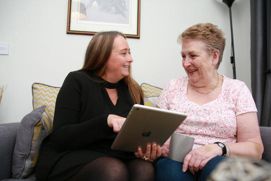Irwell Valley Employee showing the resident their ipad