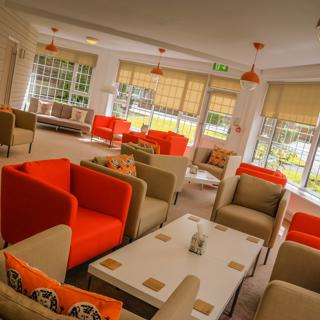 Orange and Grey chairs with matching décor in the communal room