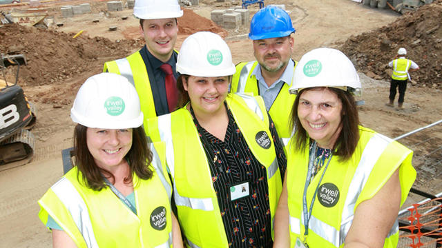Five Irwell Valley Employees at a construction site wearing hard hats