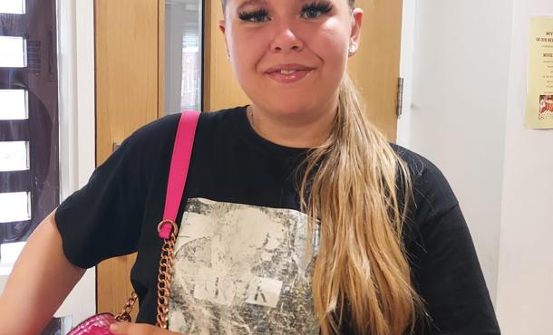 Resident at Greenbank with pink handbag