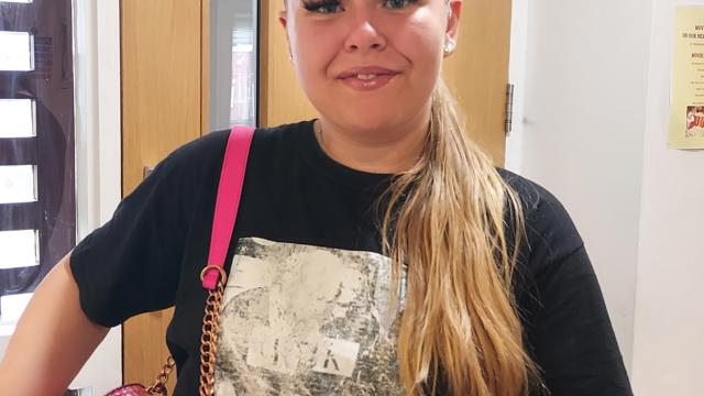 Resident at Greenbank with pink handbag