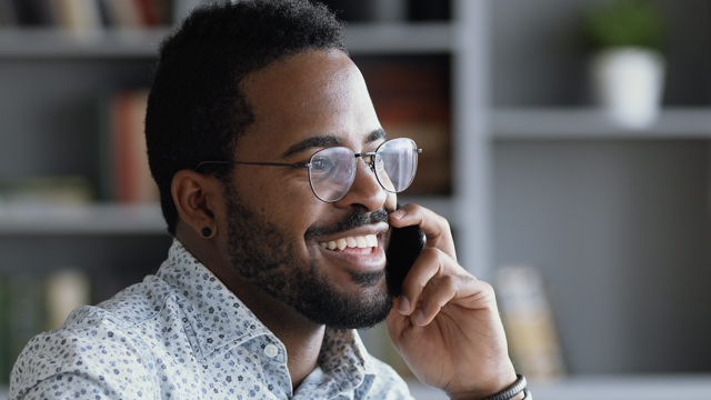 Man talking on the phone smiling 
