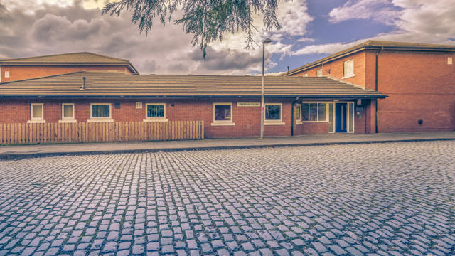 The Sideview of Peterloo Court with a cobblestone road