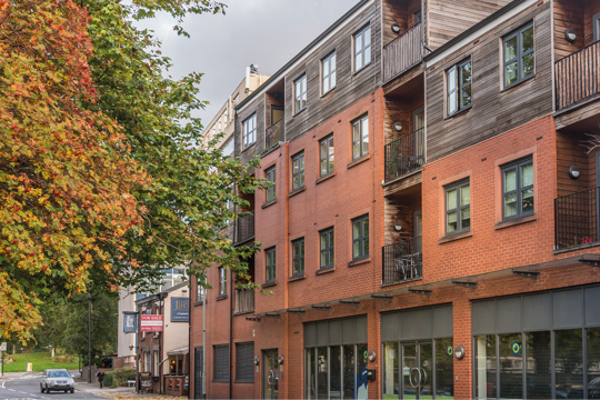 Property with wood and brick above some shops