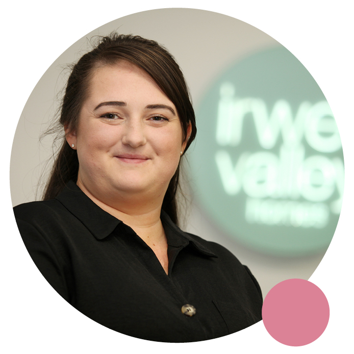 One of our Community Coordinators posing in front of the Irwell Valley Sign