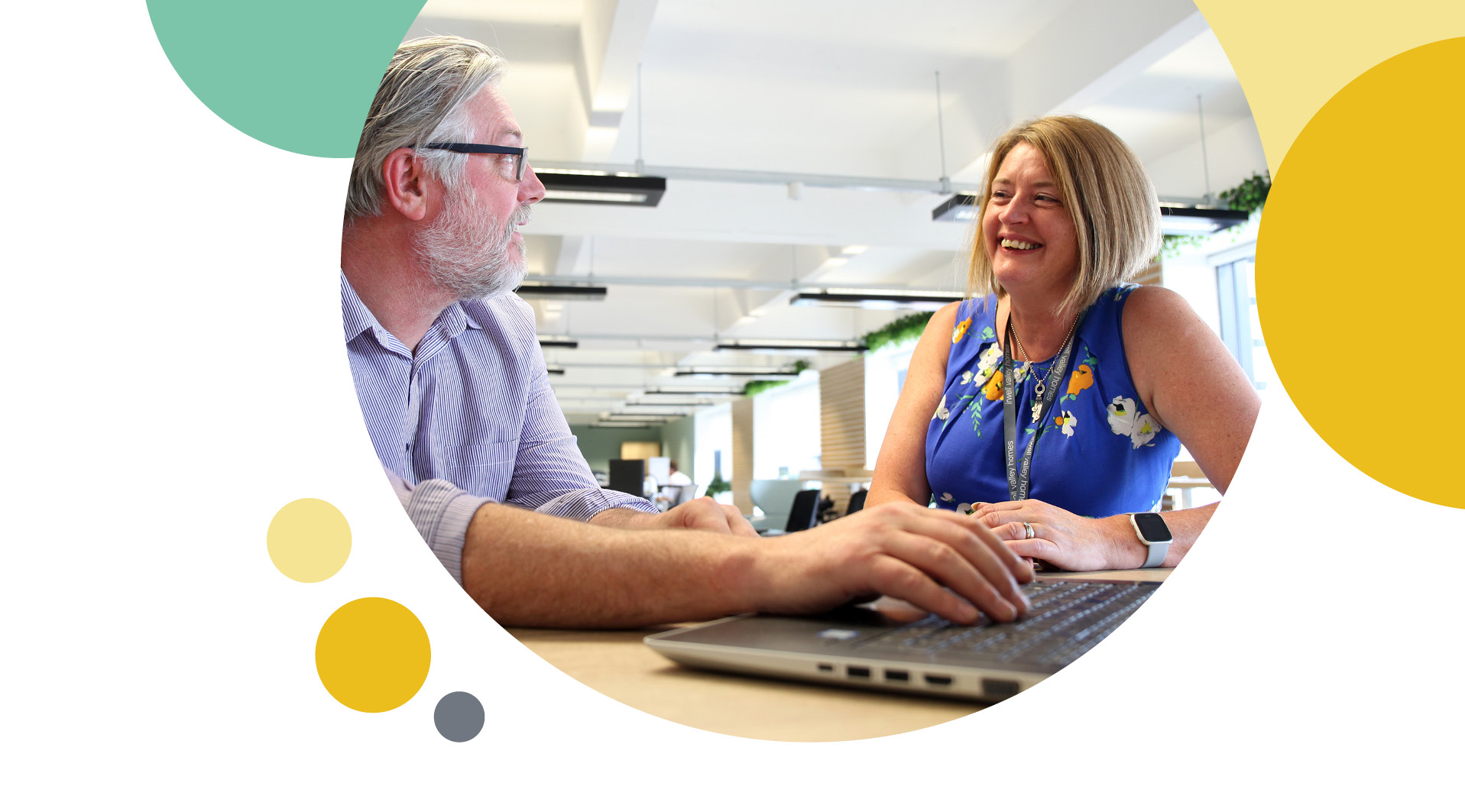 A man and woman analysing the laptop screen